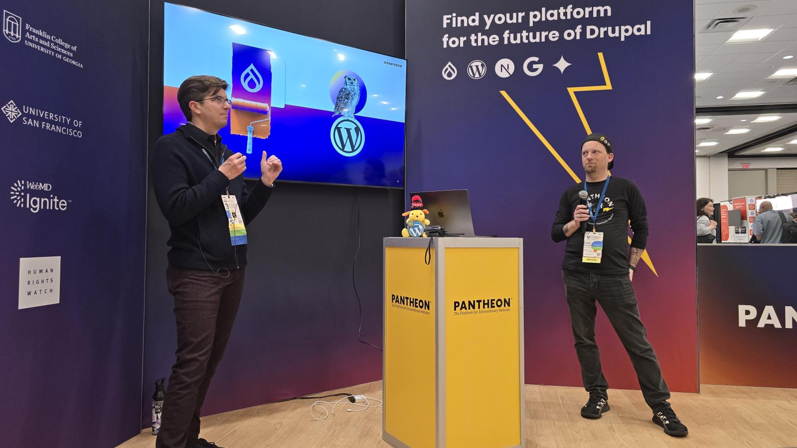 Steve Persch and Chris Reynolds presenting at the Pantheon booth at DrupalCon Atlanta 2025